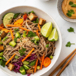 soba noodle salad with peanut sauce served in bowl